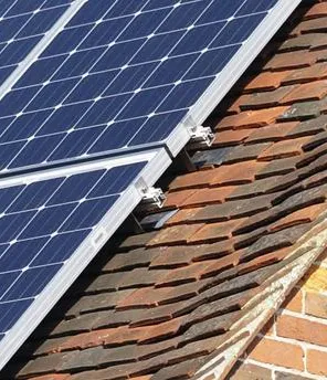 Eine Photovoltaikanlage auf dem Dach eines alten Hauses.